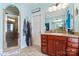 A full bathroom features a glass shower and a vanity with a vessel sink and cherry-wood colored cabinets at 4858 Sagittarius Cir, Denver, NC 28037