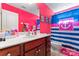 Bright bathroom with vibrant pink walls and nautical-themed shower curtain at 4858 Sagittarius Cir, Denver, NC 28037