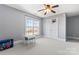 Well-lit bedroom with neutral carpet, and a large window overlooking the outdoors at 4858 Sagittarius Cir, Denver, NC 28037