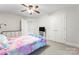 This bedroom is complete with neutral carpet, a ceiling fan and generous closet space at 4858 Sagittarius Cir, Denver, NC 28037