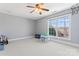 A bright bedroom with a ceiling fan, a large window, and space for play at 4858 Sagittarius Cir, Denver, NC 28037