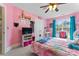 Bright pink bedroom featuring desk, decor, and natural light from a large window at 4858 Sagittarius Cir, Denver, NC 28037