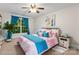 Bright bedroom with large window, ceiling fan, and a comfortable bed adorned with colorful accents at 4858 Sagittarius Cir, Denver, NC 28037