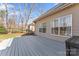 An outdoor deck features wood-look floor planks and views of the backyard at 4858 Sagittarius Cir, Denver, NC 28037