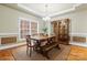 A spacious dining room features a large window, tray ceiling, and a wood table with bench seating at 4858 Sagittarius Cir, Denver, NC 28037