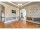 Dining room featuring hardwood floors, wainscoting, crown molding, and an airy atmosphere at 4858 Sagittarius Cir, Denver, NC 28037