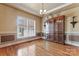Dining room showcasing hardwood floors, wainscoting, crown molding, and a grand display cabinet at 4858 Sagittarius Cir, Denver, NC 28037