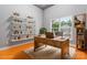 Inviting home office featuring floating shelves, wood desk, and natural light from the large window at 4858 Sagittarius Cir, Denver, NC 28037
