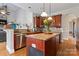 Kitchen offers stainless appliances, granite countertops and breakfast bar with a view to the living room at 4858 Sagittarius Cir, Denver, NC 28037