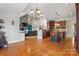 Kitchen offers stainless appliances, granite countertops and breakfast bar with a view to the living room at 4858 Sagittarius Cir, Denver, NC 28037