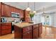 Kitchen boasts a large island, granite countertops, wood cabinets, stainless appliances and view to the breakfast area at 4858 Sagittarius Cir, Denver, NC 28037