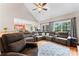 A luxurious living room features a sectional sofa, hardwood floors, and lots of natural light at 4858 Sagittarius Cir, Denver, NC 28037