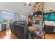 Living room featuring stone fireplace, built-in shelving, large windows, and vaulted ceilings at 4858 Sagittarius Cir, Denver, NC 28037