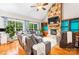 Spacious living room boasts a stone fireplace, hardwood floors, and plenty of natural light at 4858 Sagittarius Cir, Denver, NC 28037
