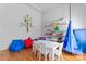 Bright playroom featuring cheerful décor, a white table set, and cozy beanbag chairs at 4858 Sagittarius Cir, Denver, NC 28037