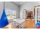 Bright playroom featuring cheerful décor, a white table set, and a swinging blue chair at 4858 Sagittarius Cir, Denver, NC 28037