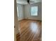 Bright bedroom featuring gleaming hardwood floors, neutral walls, and natural light from the windows at 501 Franklin Ave, Shelby, NC 28150