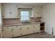 Cozy kitchen featuring ample cabinet space, laminate countertops, and a stainless steel sink at 501 Franklin Ave, Shelby, NC 28150