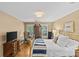 Comfortable bedroom featuring a gold bed, dresser, hardwood floors, and natural light, creating a cozy atmosphere at 5114 Morrowick Rd, Charlotte, NC 28226