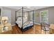 Bedroom featuring a four poster bed frame, hardwood floors, and lots of natural light at 5114 Morrowick Rd, Charlotte, NC 28226