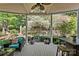 Relaxing covered patio area overlooking lush garden and serene water feature in backyard at 5114 Morrowick Rd, Charlotte, NC 28226