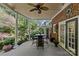 Inviting covered patio with dining area, offering views of the lush backyard and garden with water feature at 5114 Morrowick Rd, Charlotte, NC 28226