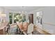 Dining room with hardwood floors, bright windows, elegant furniture, and access to the kitchen at 5114 Morrowick Rd, Charlotte, NC 28226