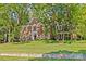 Beautiful brick home surrounded by mature trees and a well-manicured lawn provides great curb appeal at 5114 Morrowick Rd, Charlotte, NC 28226