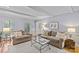 Bright and airy living room with hardwood floors, neutral furniture, and plantation shutters at 5114 Morrowick Rd, Charlotte, NC 28226