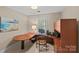Home office with a built-in desk, custom cabinetry, and window at 5114 Morrowick Rd, Charlotte, NC 28226