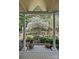 Covered patio view showcasing a meticulously landscaped yard with a peaceful pond feature at 5114 Morrowick Rd, Charlotte, NC 28226