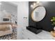 Modern bathroom features a sleek black sink, gold fixtures, and a trendy round mirror at 680 Ideal Way, Charlotte, NC 28203