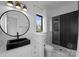 Stylish bathroom with black herringbone tile in the shower and modern fixtures at 680 Ideal Way, Charlotte, NC 28203
