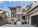 A beautiful two-story home featuring white brick, black trim, a modern front door, and well-manicured landscaping at 680 Ideal Way, Charlotte, NC 28203