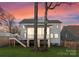 Back of a beautifully lit two-story home at sunset with a green lawn and fenced yard at 680 Ideal Way, Charlotte, NC 28203