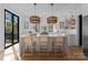Bright kitchen with a large island, pendant lighting, and sliding door access to the outside at 680 Ideal Way, Charlotte, NC 28203