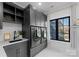 Well-appointed laundry room with modern washer and dryer, custom cabinetry, and natural light at 680 Ideal Way, Charlotte, NC 28203