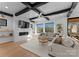 Bright living room with modern fireplace, beamed ceilings, and large windows, providing natural light and outdoor views at 680 Ideal Way, Charlotte, NC 28203