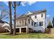 This home's rear exterior features a screened porch with access to the backyard, complemented by a well-maintained lawn at 680 Ideal Way, Charlotte, NC 28203