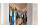 Walk-in closet with hanging racks for clothes, stacked storage, and personal items at 7327 Carrbridge Ln, Charlotte, NC 28226