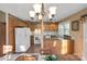 Bright kitchen featuring wood cabinetry, appliances, and decorative border at 7327 Carrbridge Ln, Charlotte, NC 28226