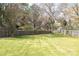 Well-maintained backyard featuring lush green grass and mature trees and fence at 7343 Rock Island Rd, Charlotte, NC 28278