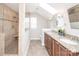 Spacious bathroom featuring double vanity, granite countertop and a tiled walk-in shower with a bench at 7343 Rock Island Rd, Charlotte, NC 28278