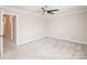 Bright bedroom with neutral walls and carpet flooring and a ceiling fan at 7343 Rock Island Rd, Charlotte, NC 28278