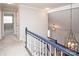 Hallway featuring a blue and white banister, chandelier, and access to multiple rooms at 7343 Rock Island Rd, Charlotte, NC 28278