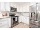 Bright kitchen featuring white cabinets, stainless steel appliances, and modern finishes at 7343 Rock Island Rd, Charlotte, NC 28278