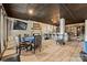 Finished basement area featuring a stone fireplace, tv, a poker table and a full bar at 8014 Kiwi Pt, Tega Cay, SC 29708