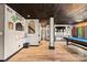 Finished basement with a wood plank ceiling, a pool table, and a bar area for entertaining at 8014 Kiwi Pt, Tega Cay, SC 29708