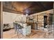 Basement showcasing a bar area with seating, stone accent, and a wood plank accent wall at 8014 Kiwi Pt, Tega Cay, SC 29708