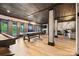 Basement boasting a pool table, full bar, natural light, and stylish architectural columns at 8014 Kiwi Pt, Tega Cay, SC 29708